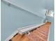 Light blue staircase equipped with stair lift for convenient access at 6435 Sedgeford Dr, Lakeland, FL 33811