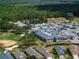Gorgeous aerial view of community amenities including pool, clubhouse, golf, and lush green space at 645 Whisper Woods Dr, Lakeland, FL 33813