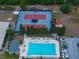 Overhead view of the community pool, tennis courts, landscaping, and parking areas at 645 Whisper Woods Dr, Lakeland, FL 33813