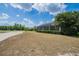 Spacious backyard with manicured lawn and screened lanai offering views of the golf course at 645 Whisper Woods Dr, Lakeland, FL 33813