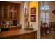 Bar area complete with granite counters, wine storage and glass shelving at 645 Whisper Woods Dr, Lakeland, FL 33813