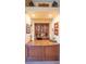 Built-in bar area with granite countertops, wine fridge, and display cabinets at 645 Whisper Woods Dr, Lakeland, FL 33813