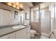 Bathroom with a sink, vanity, toilet and shower with glass door enclosure at 645 Whisper Woods Dr, Lakeland, FL 33813