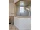 Bright bathroom featuring a glass shower and neutral-toned walls with a decorative pattern at 645 Whisper Woods Dr, Lakeland, FL 33813
