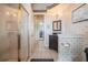 Bathroom featuring a glass-enclosed shower and a hallway leading to other rooms at 645 Whisper Woods Dr, Lakeland, FL 33813
