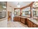 Spacious bathroom featuring a large vanity with double sinks and decorative lighting, alongside a glass-enclosed shower at 645 Whisper Woods Dr, Lakeland, FL 33813