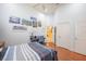 A well-lit bedroom has a desk, chair, and a bed with striped bedding and wood flooring at 645 Whisper Woods Dr, Lakeland, FL 33813