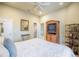 Cozy bedroom featuring a ceiling fan, a large TV, and ample storage space at 645 Whisper Woods Dr, Lakeland, FL 33813