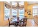 Elegant dining area with a chandelier and a view overlooking the pool at 645 Whisper Woods Dr, Lakeland, FL 33813