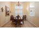 Traditional dining room with wood table, decorative chandelier, and large window with plantation shutters at 645 Whisper Woods Dr, Lakeland, FL 33813