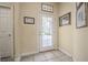 Bright entryway with a glass-paneled door, tile flooring, and decorative wall art at 645 Whisper Woods Dr, Lakeland, FL 33813
