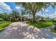 Elegant home featuring a circular driveway and lush landscaping, offering a grand entrance and inviting atmosphere at 645 Whisper Woods Dr, Lakeland, FL 33813