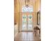 Elegant foyer with decorative front doors, neutral tile flooring, and high ceilings at 645 Whisper Woods Dr, Lakeland, FL 33813