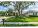 Beautiful home showcasing a lush front yard with mature trees and manicured landscaping, enhancing curb appeal and charm at 645 Whisper Woods Dr, Lakeland, FL 33813