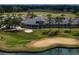 A scenic golf course with lush greenery, a tranquil pond, and golfers enjoying the game in a picturesque setting at 645 Whisper Woods Dr, Lakeland, FL 33813