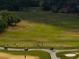 A expansive, well-kept golf course presents a lush, verdant landscape with manicured fairways and mature trees at 645 Whisper Woods Dr, Lakeland, FL 33813