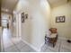 Neutral hallway with tile flooring, decorative wall art, and a seating area at 645 Whisper Woods Dr, Lakeland, FL 33813