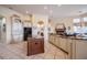 Open kitchen with an island, breakfast bar, and sleek black appliances at 645 Whisper Woods Dr, Lakeland, FL 33813