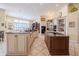 Bright kitchen with custom cabinets, central island, and plenty of countertop space at 645 Whisper Woods Dr, Lakeland, FL 33813