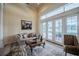 Cozy living area with a fireplace, French doors offering a view, and ample natural light at 645 Whisper Woods Dr, Lakeland, FL 33813