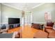Cozy living room boasts comfortable furniture, bright lighting, and beautiful wood floors at 645 Whisper Woods Dr, Lakeland, FL 33813