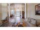 Spacious living room with tile floors, columns, and a view into the foyer and formal dining area at 645 Whisper Woods Dr, Lakeland, FL 33813