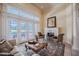 Inviting living area featuring a fireplace, French doors leading to the outdoors, and neutral decor at 645 Whisper Woods Dr, Lakeland, FL 33813