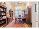Spacious office with hardwood floors, a large window, and ample built-in shelving at 645 Whisper Woods Dr, Lakeland, FL 33813
