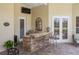 Covered outdoor kitchen with granite countertops and brick accents, excellent for entertaining at 645 Whisper Woods Dr, Lakeland, FL 33813