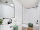Bright bathroom with white subway tile, modern black fixtures, and white vanity at 6527 Fernwood Dr, Lakeland, FL 33810