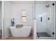 Beautiful bathroom features a freestanding tub, walk-in glass shower, and modern fixtures at 6527 Fernwood Dr, Lakeland, FL 33810