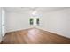 Bright bedroom features laminate flooring, a ceiling fan, fresh paint, and natural light at 6527 Fernwood Dr, Lakeland, FL 33810