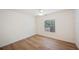 Cozy bedroom with laminate flooring, neutral paint, a ceiling fan, and natural light at 6527 Fernwood Dr, Lakeland, FL 33810