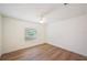 Bright bedroom with hardwood flooring, ceiling fan, and natural light from the window at 6527 Fernwood Dr, Lakeland, FL 33810