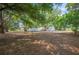 Home exterior with a large yard, mature trees and shed, ideal for outdoor enjoyment at 6527 Fernwood Dr, Lakeland, FL 33810