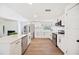 Beautiful kitchen with stainless appliances, granite counters, laminate flooring, and white shaker cabinets at 6527 Fernwood Dr, Lakeland, FL 33810