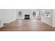 Bright living room featuring laminate flooring, a modern fireplace, and seamless access to the kitchen at 6527 Fernwood Dr, Lakeland, FL 33810