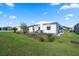 Well-kept backyard with lush green lawn, small garden, and bright sky, perfect for outdoor enjoyment at 6731 Canterbury Ne Dr, Winter Haven, FL 33881