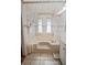 Inviting bathroom showcasing a tiled tub with a privacy curtain, perfect for relaxation at 6731 Canterbury Ne Dr, Winter Haven, FL 33881