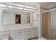 Bathroom with a long countertop and enclosed shower, complemented by floral accents at 6731 Canterbury Ne Dr, Winter Haven, FL 33881