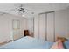 Comfortable bedroom featuring wood-look floors, ceiling fan, and a spacious closet at 6731 Canterbury Ne Dr, Winter Haven, FL 33881