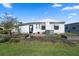Cozy home with a small garden area and a well-manicured lawn under a bright sky at 6731 Canterbury Ne Dr, Winter Haven, FL 33881