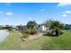 Charming single-story home featuring well-maintained landscaping and verdant lawn under a blue sky at 6731 Canterbury Ne Dr, Winter Haven, FL 33881