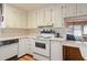 Cozy kitchen featuring ample cabinet and counter space, with a view to the living room at 6731 Canterbury Ne Dr, Winter Haven, FL 33881