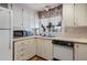 Classic kitchen featuring ample white cabinetry, a microwave, and a dishwasher at 6731 Canterbury Ne Dr, Winter Haven, FL 33881