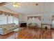 Bright living room showcasing wood floors, plenty of natural light, and comfortable seating at 6731 Canterbury Ne Dr, Winter Haven, FL 33881