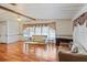 Spacious living room with wood floors, large windows, and comfortable seating area at 6731 Canterbury Ne Dr, Winter Haven, FL 33881