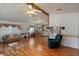 Bright open-concept living room with wood flooring and an open dining area at 6731 Canterbury Ne Dr, Winter Haven, FL 33881