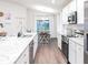 Modern kitchen with granite countertops, stainless steel appliances, and an adjacent dining area at 702 Bentley North Loop, Auburndale, FL 33823