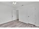Bedroom with light gray wood flooring, white trim, and white doors, creating a clean and modern aesthetic at 725 Avenue B Sw, Winter Haven, FL 33880